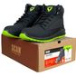 Black safety boots with green accents on a cardboard box labeled 'SCAN'.