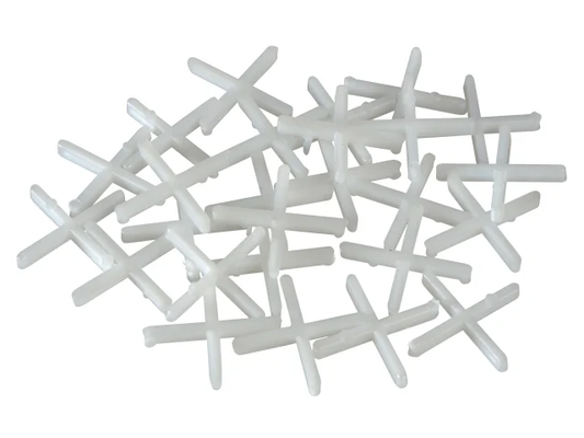White plastic crosses on a white background