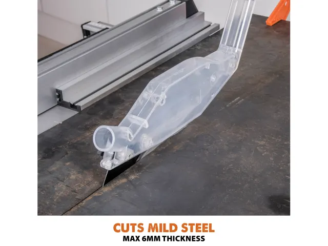 CNC machine cutting mild steel with a clear plastic component on a dark surface.