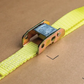 Yellow strap with metal buckle on a brown background