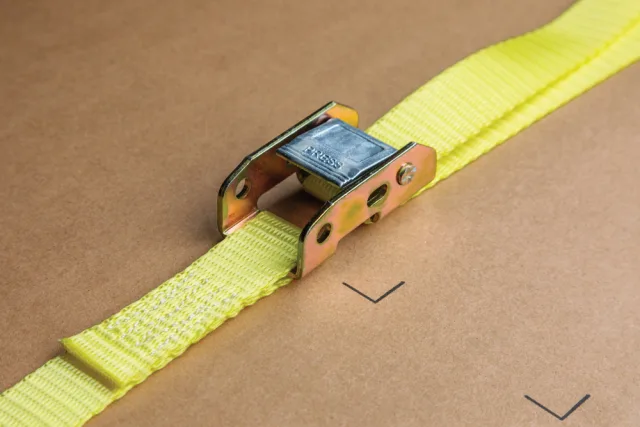 Yellow strap with metal buckle on a brown background