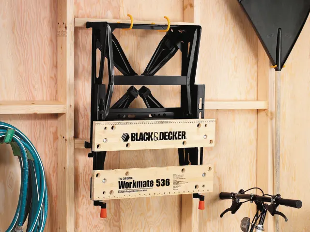 Black & Decker Workmate 536 tool on a wooden wall with a hose and bike in the background