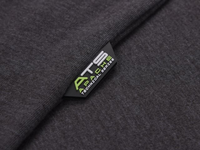 Close-up of a dark gray fabric with a brand label on a matching background