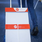 Person pushing a folding cart with 'tec' branding on a blue floor.
