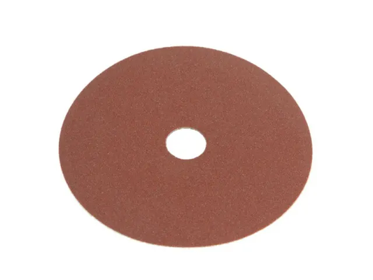 Round sanding disc with a central hole on a white background